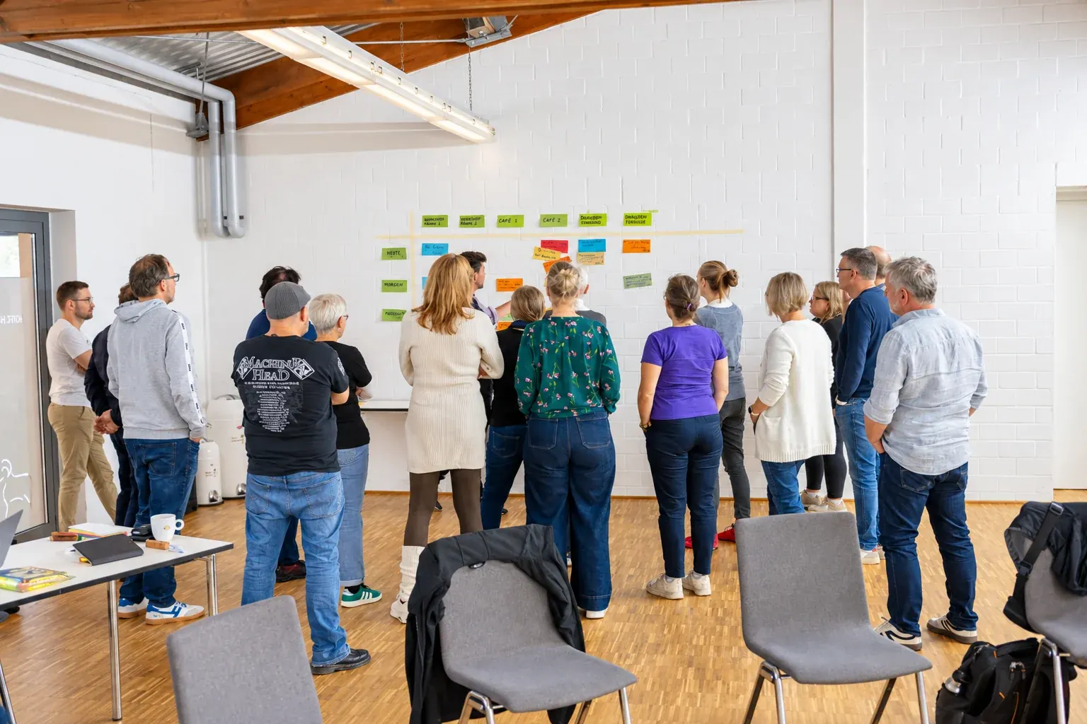 Workshop participants work in small groups in a bright hall