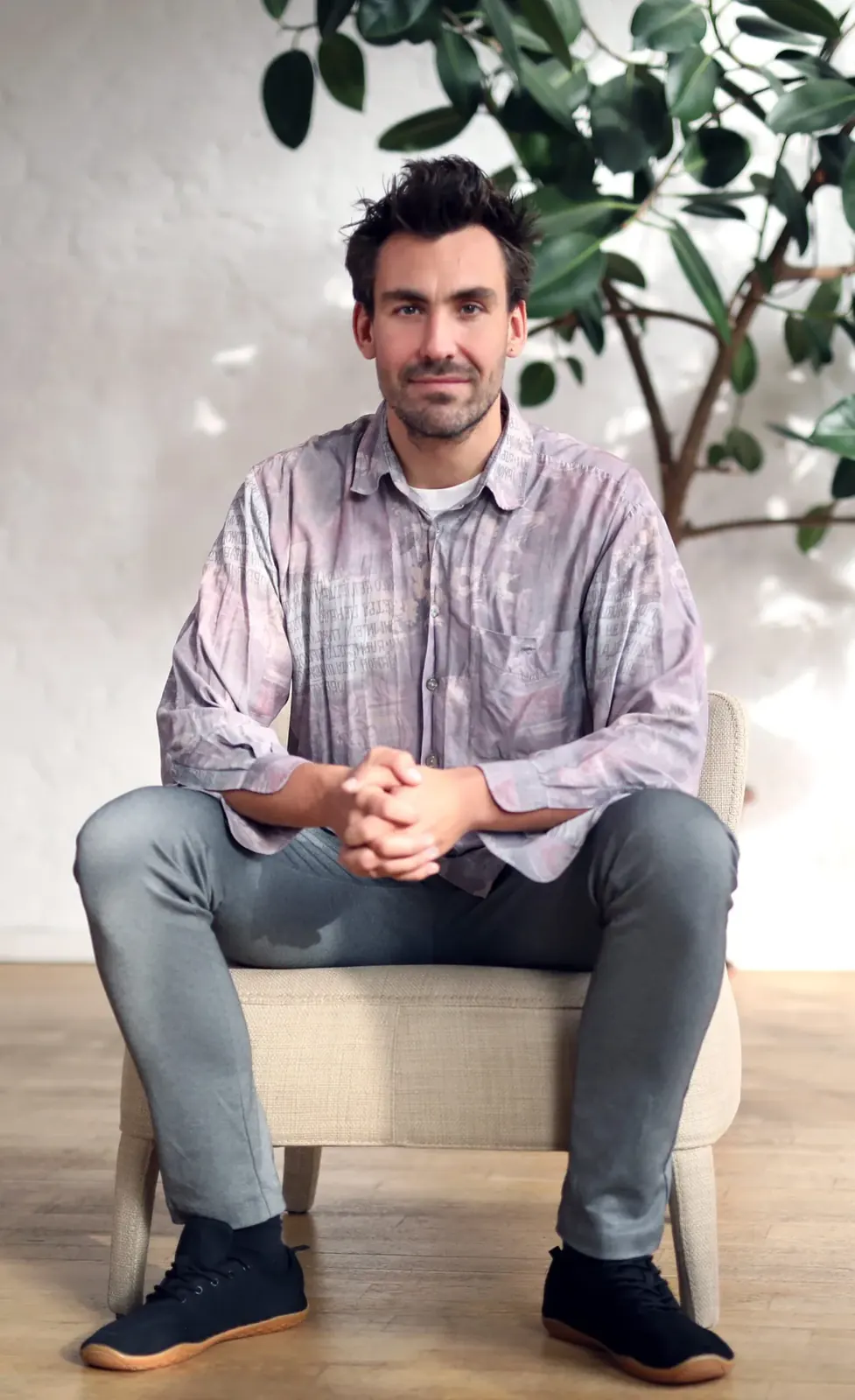 Robin Hotz sitting on a stool, smiling
