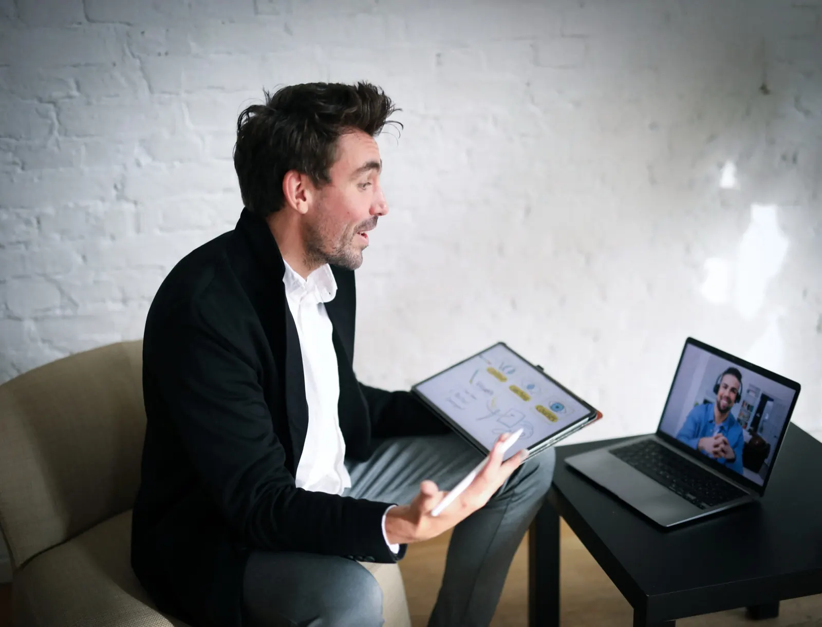 Robin Hotz in a 1:1 coaching session on a video call, holding a tablet